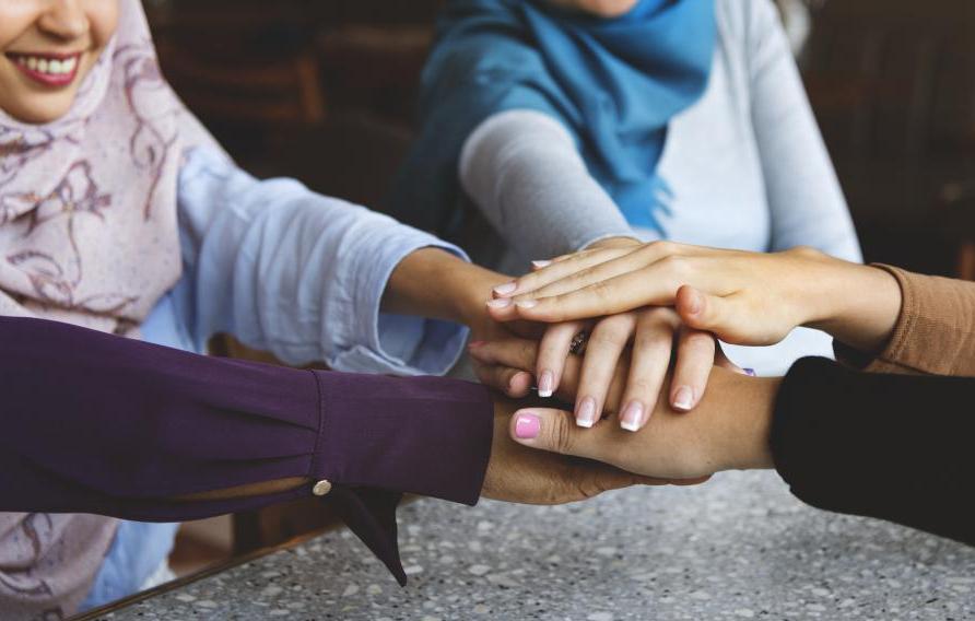 Islamic friends hands stack for teamwork